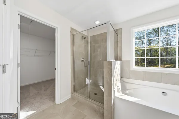 a bathroom with a bathtub shower and a sink