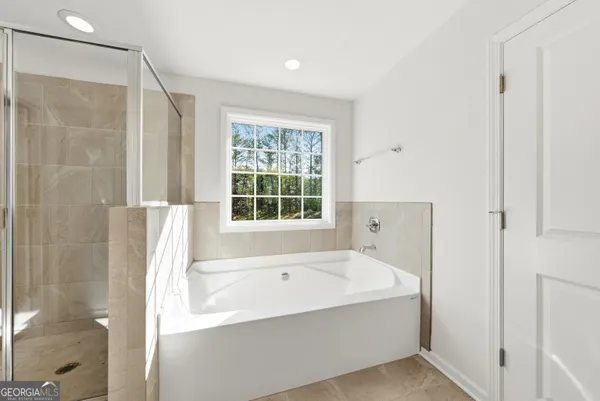 a bathroom with a bathtub and a shower