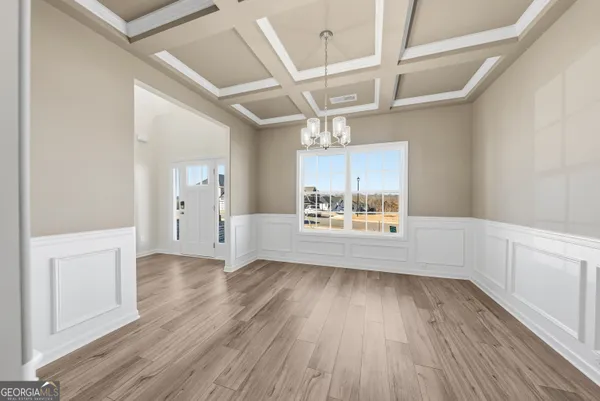 a view of a kitchen and wooden floor