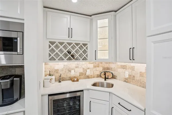 a sink with a stove and cabinets