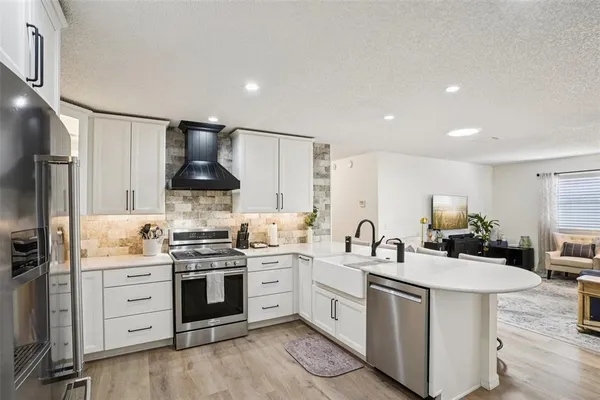 a kitchen with a sink stove and cabinets