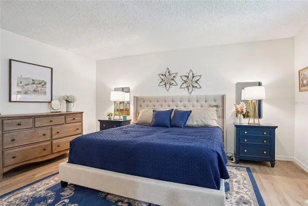 a bedroom with a bed and cabinet