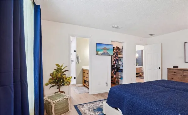 a bedroom with a large bed and a closet