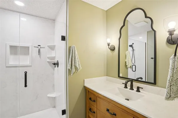 a bathroom with a sink and mirror with toilet