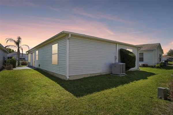 a backyard of a house with table and chairs