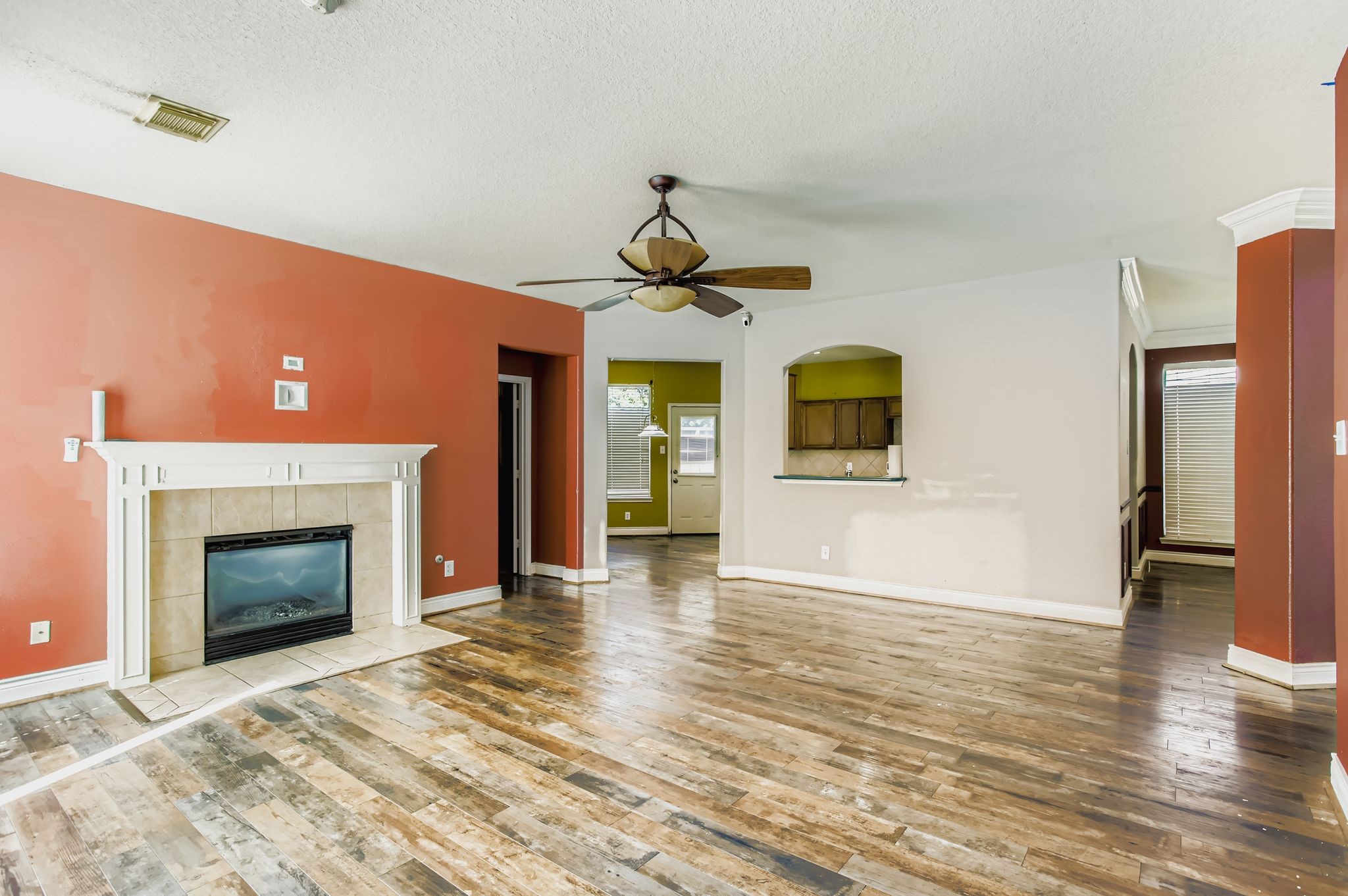 727 Pine Thicket Court Spring, TX 77373 - Photo 14 of 29 a view of a livingroom with wooden floor and a fireplace