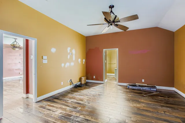 a view of a room with a ceiling fan