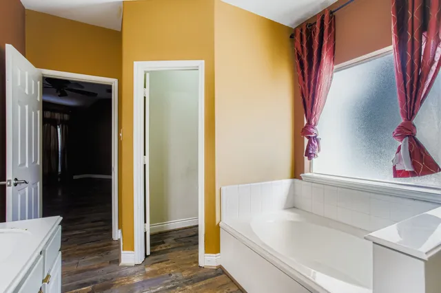a bathroom with a bathtub and a shower