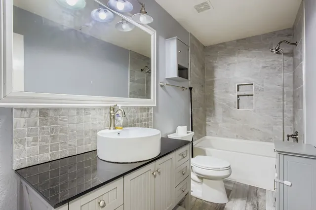 a bathroom with a bathtub and a shower