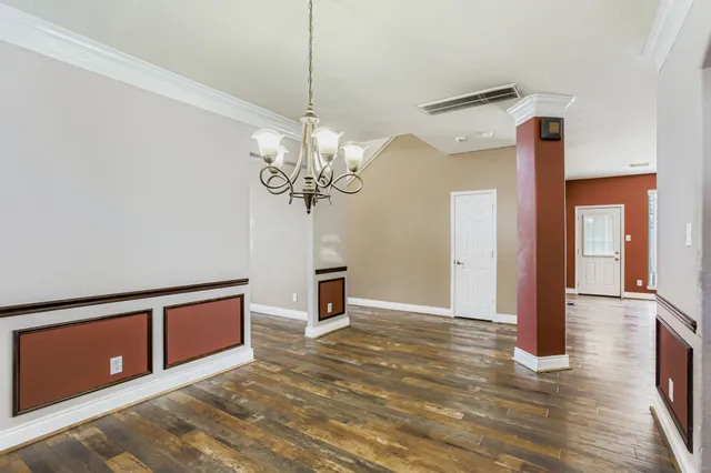 a view of an empty room with a chandelier