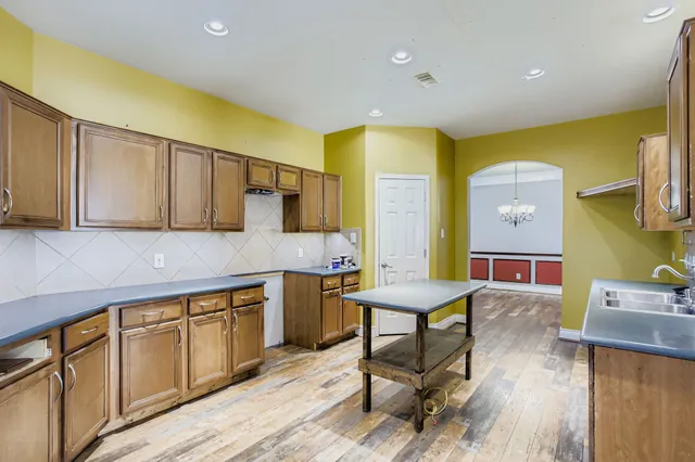 a kitchen with stainless steel appliances granite countertop a sink and cabinets