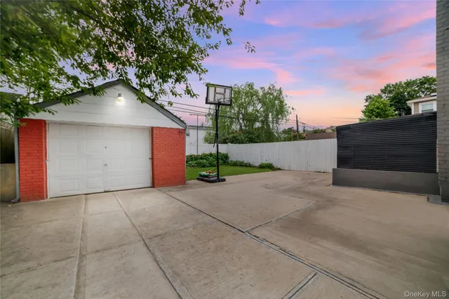 front view of a house with a yard and a garage