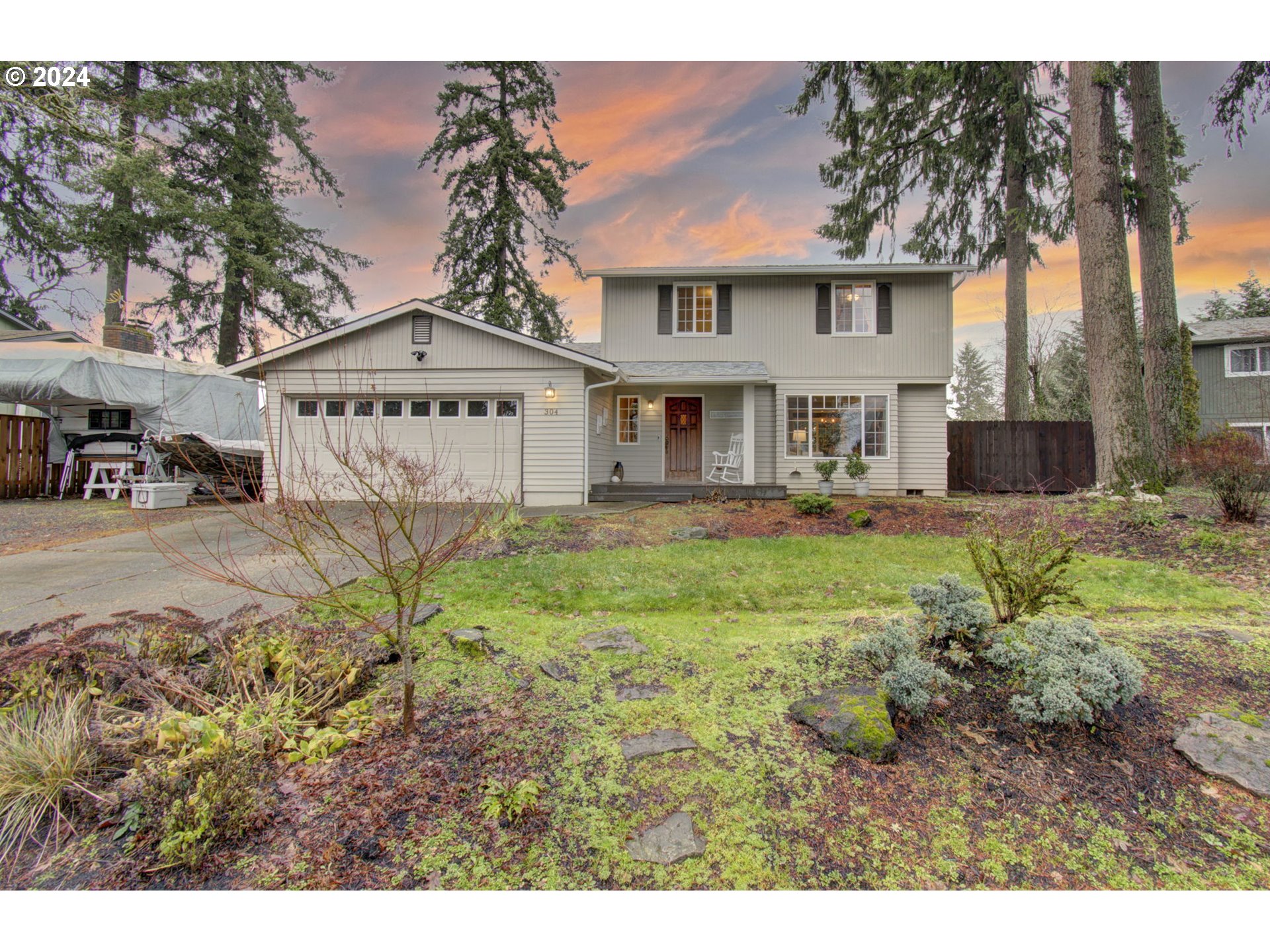 304 Northwest 8th Street Battle Ground, WA 98604 - Photo 1 of 35 a view of a white house next to a yard with big trees