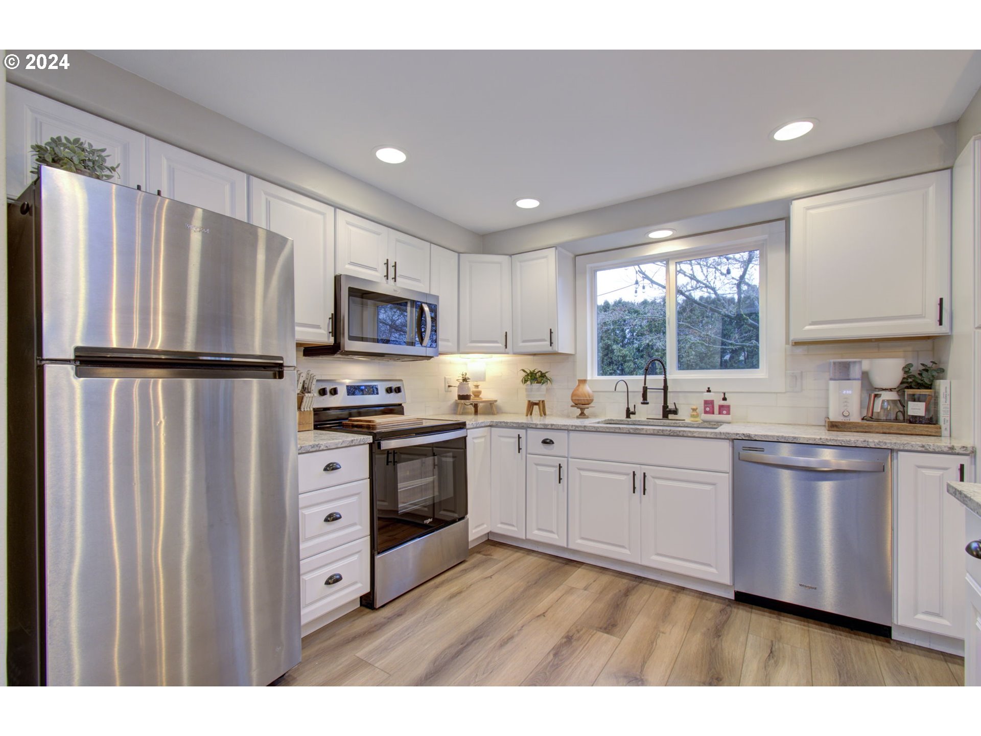 304 Northwest 8th Street Battle Ground, WA 98604 - Photo 16 of 35 a kitchen with stainless steel appliances granite countertop a refrigerator sink and microwave