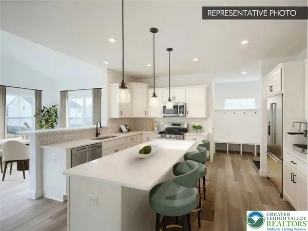 a large kitchen with a table and chairs