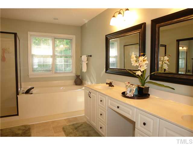 11612 Shavenrock Place Raleigh, NC 27613 - Photo 15 of 25 a bathroom with a granite countertop sink mirror bathtub and shower
