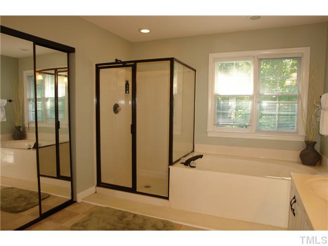 11612 Shavenrock Place Raleigh, NC 27613 - Photo 16 of 25 a bathroom with a bathtub and a shower