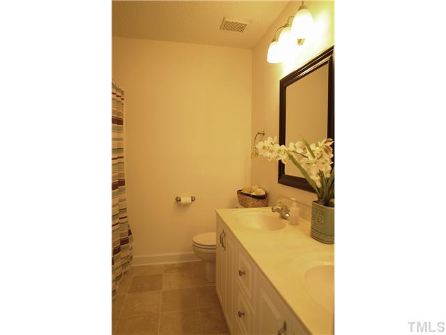 11612 Shavenrock Place Raleigh, NC 27613 - Photo 20 of 25 a bathroom with a sink and a mirror