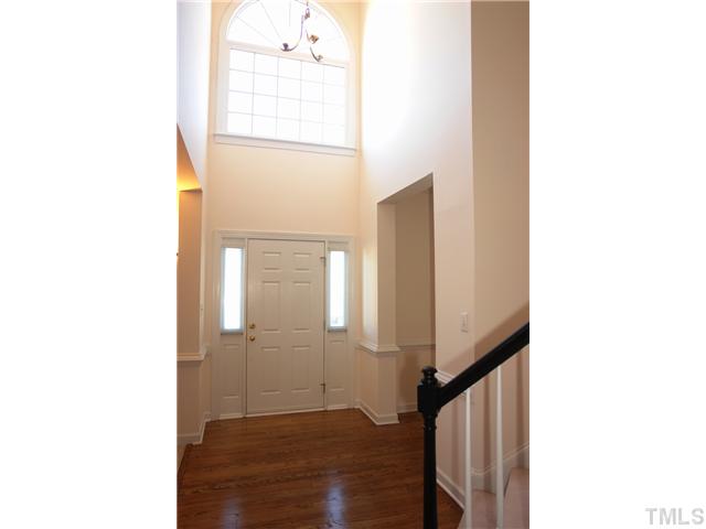 11612 Shavenrock Place Raleigh, NC 27613 - Photo 3 of 25 a view of a hallway with wooden floor