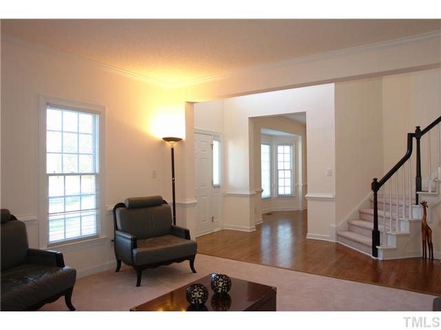 11612 Shavenrock Place Raleigh, NC 27613 - Photo 4 of 25 a living room with furniture and a wooden floor