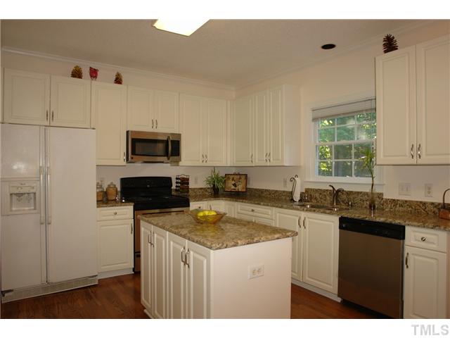11612 Shavenrock Place Raleigh, NC 27613 - Photo 8 of 25 a kitchen with a sink a stove a microwave and refrigerator