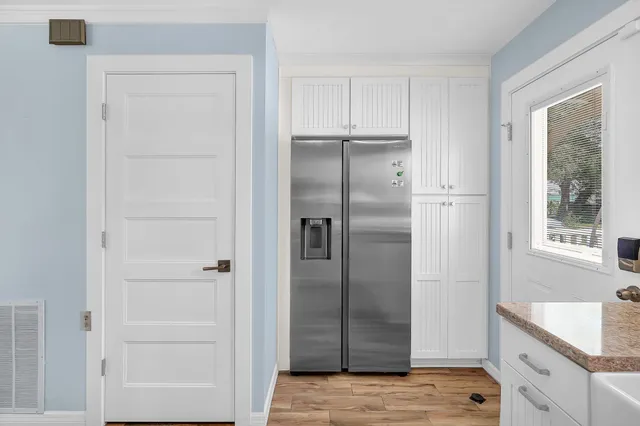 a kitchen with a refrigerator and window