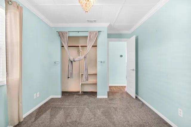 a view of empty room with a hallway