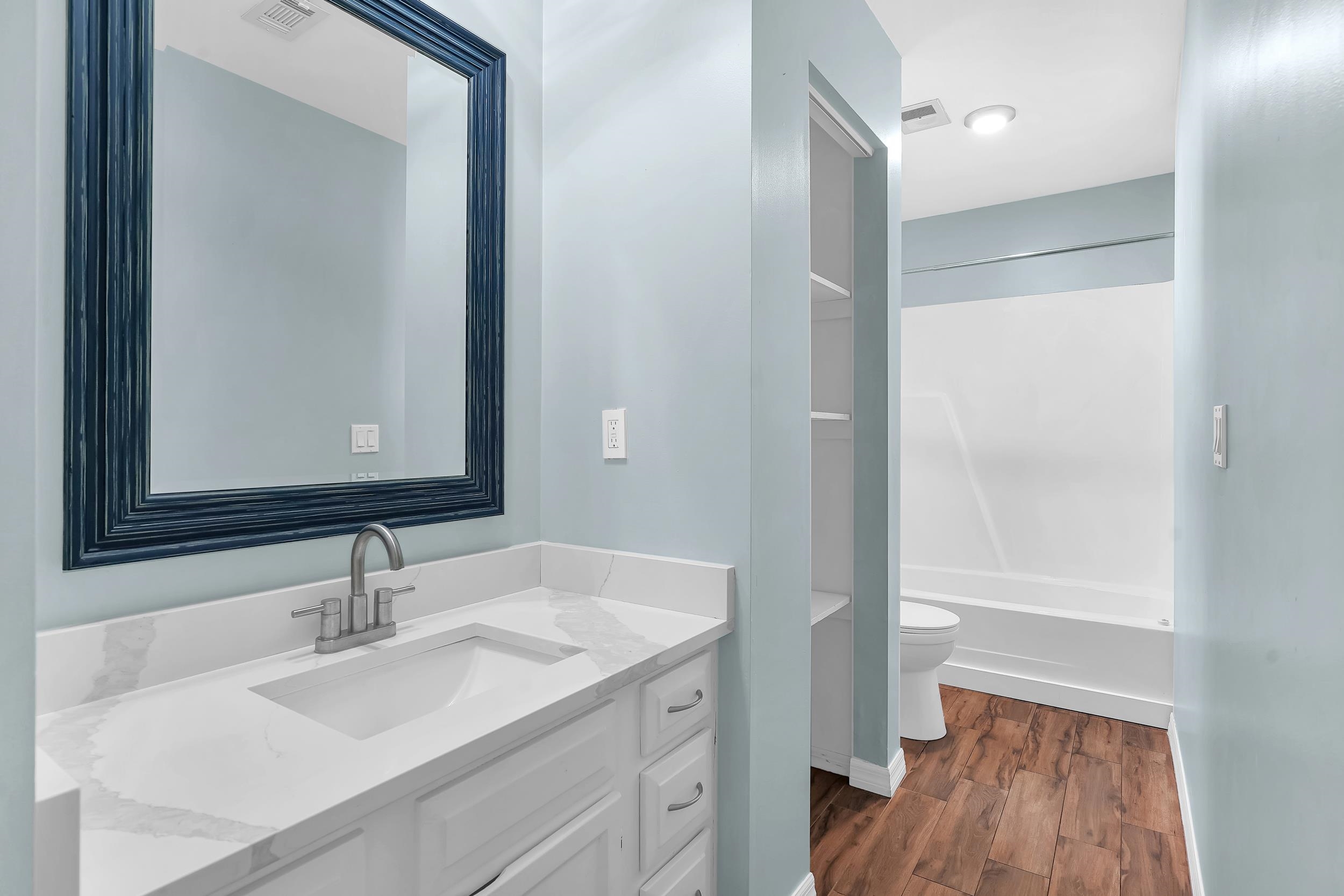 401 E Street St. Augustine, FL 32080 - Photo 17 of 36 a bathroom with a sink and a mirror