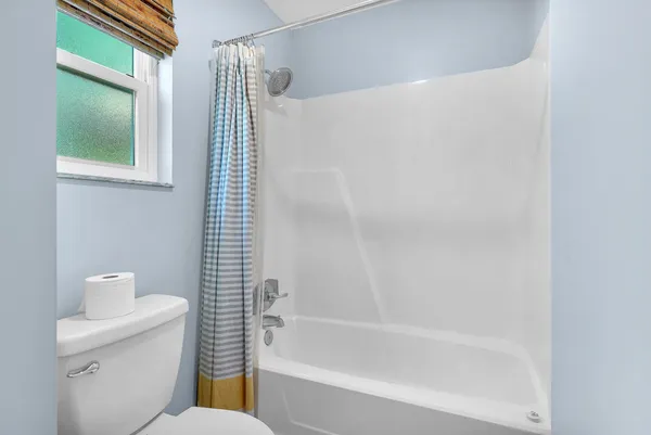 a bathroom with a toilet and shower