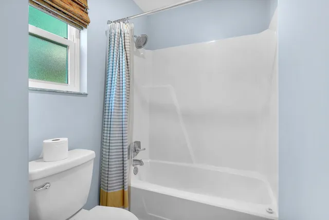 a bathroom with a toilet and shower