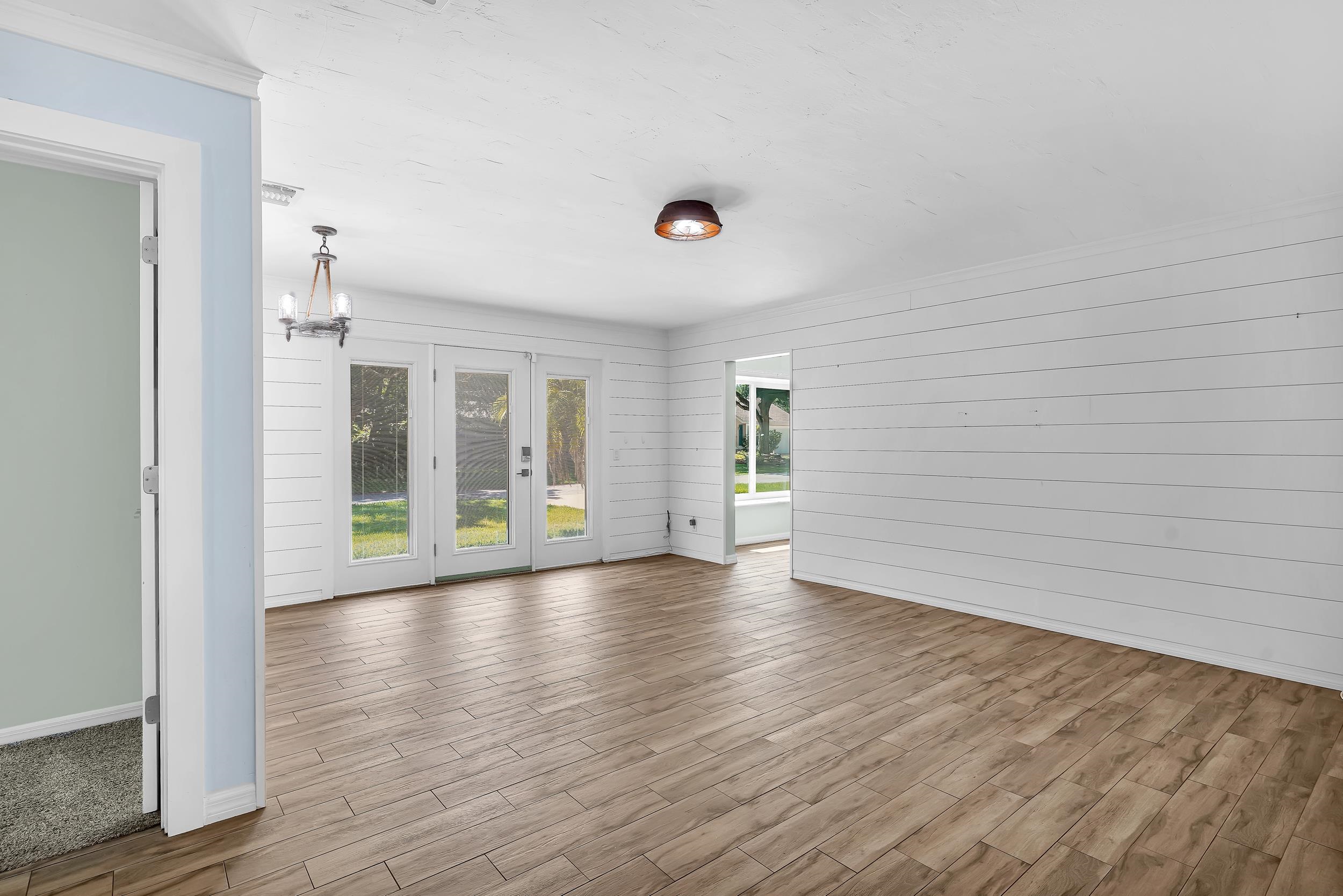 401 E Street St. Augustine, FL 32080 - Photo 21 of 36 a view of an empty room with wooden floor and a window
