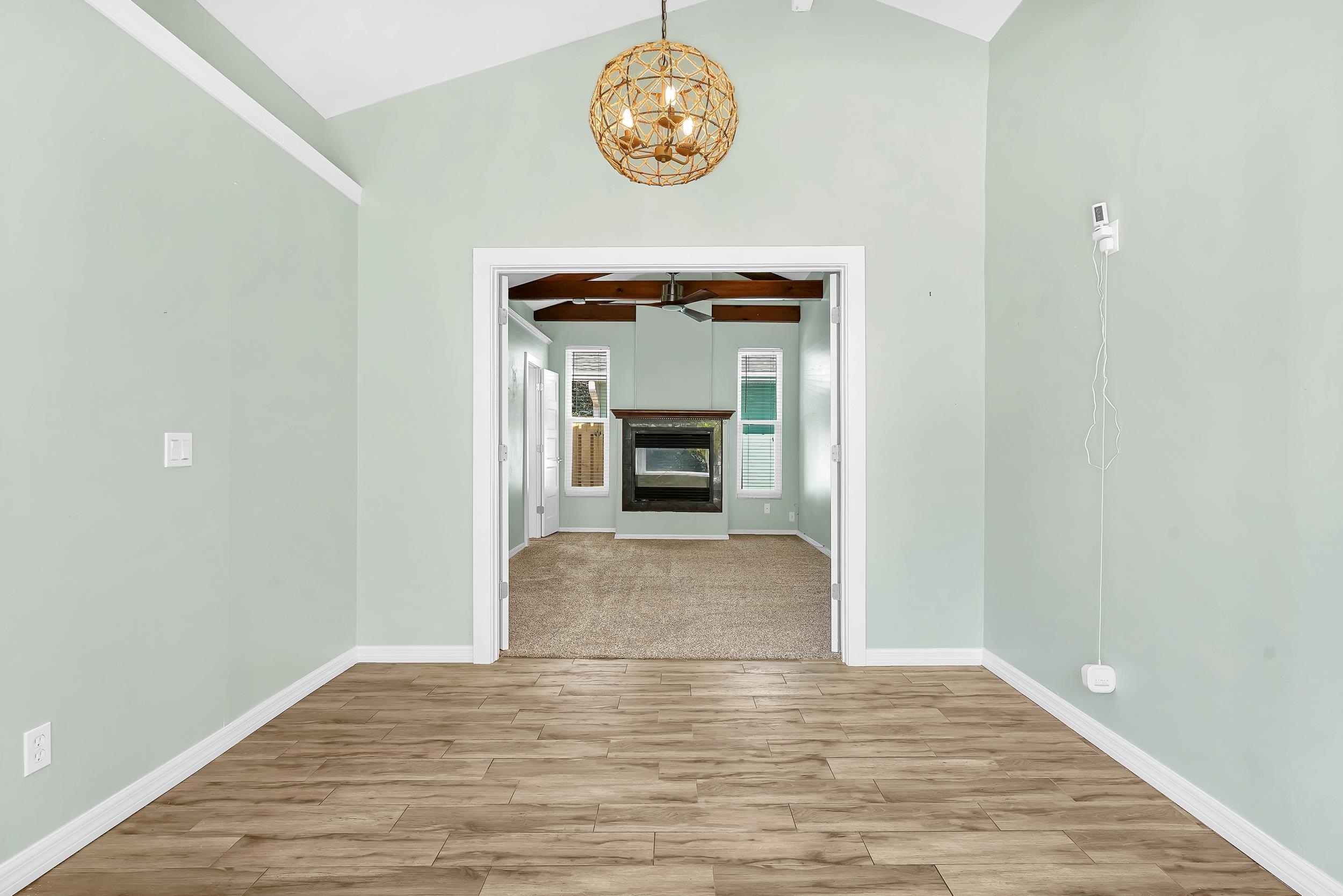 401 E Street St. Augustine, FL 32080 - Photo 23 of 36 a view of an empty room with wooden floor and a fireplace