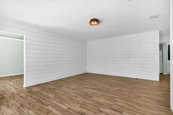 a view of a livingroom with furniture and wooden floor