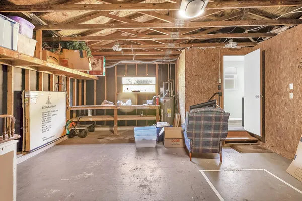 a view of a house with a yard and potted plants