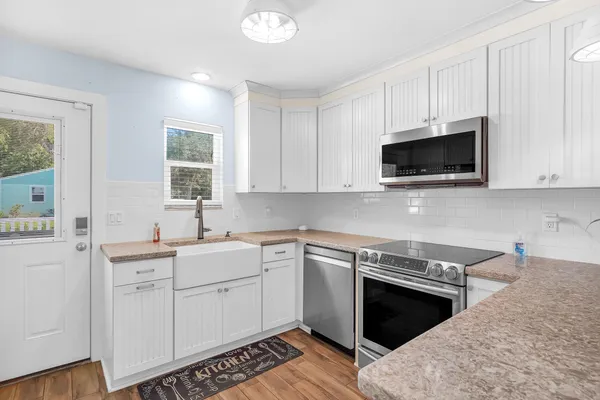 a kitchen with a sink stove and microwave