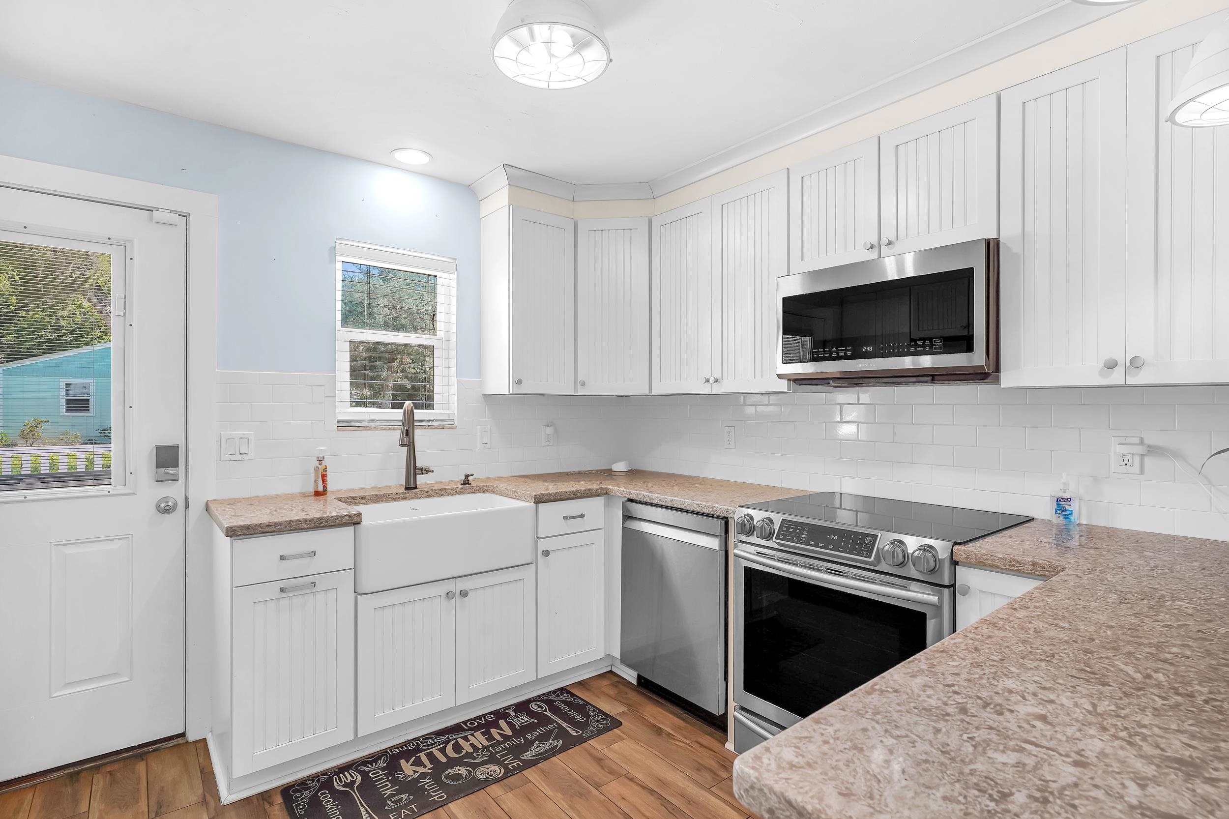 401 E Street St. Augustine, FL 32080 - Photo 6 of 36 a kitchen with a sink stove and microwave
