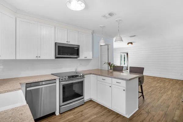 a kitchen with a sink stove and microwave