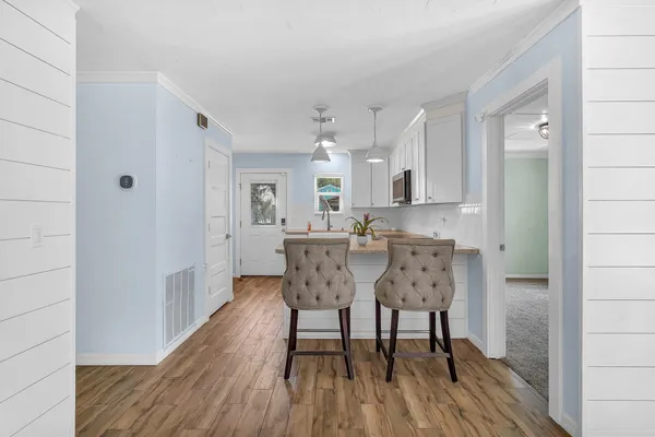 a view of a dining room with furniture and wooden floor