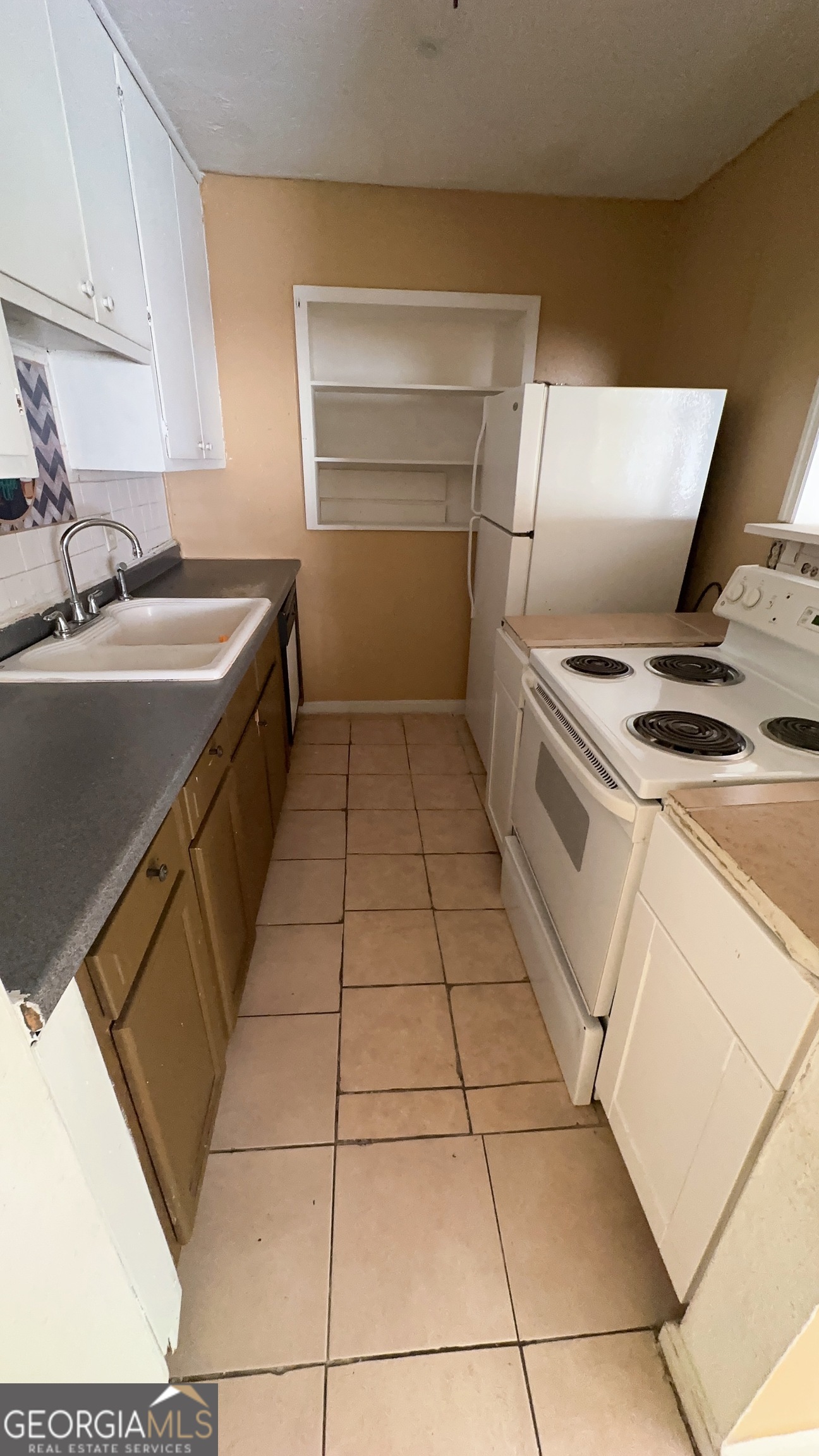 544 Conley Road Forest Park, GA 30297 - Photo 4 of 17 a kitchen with a sink a stove and cabinets