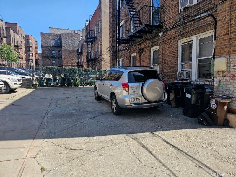 43-32 40th Street Queens, NY 11104 - Photo 13 of 14 a car parked in front of a brick building