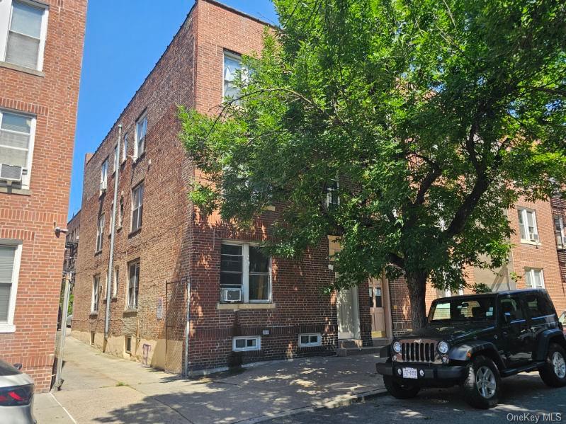 43-32 40th Street Queens, NY 11104 - Photo 2 of 14 a couple of cars parked in front of a building