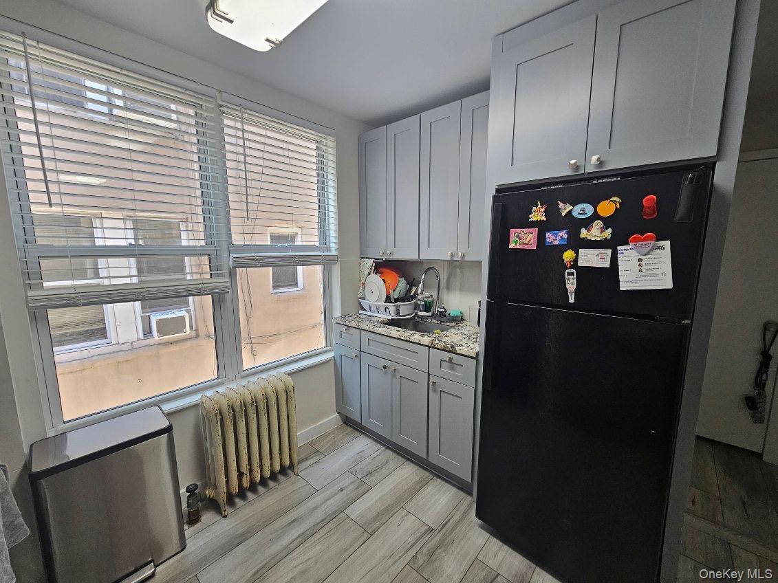 43-32 40th Street Queens, NY 11104 - Photo 8 of 14 a kitchen with granite countertop a refrigerator and a stove top oven