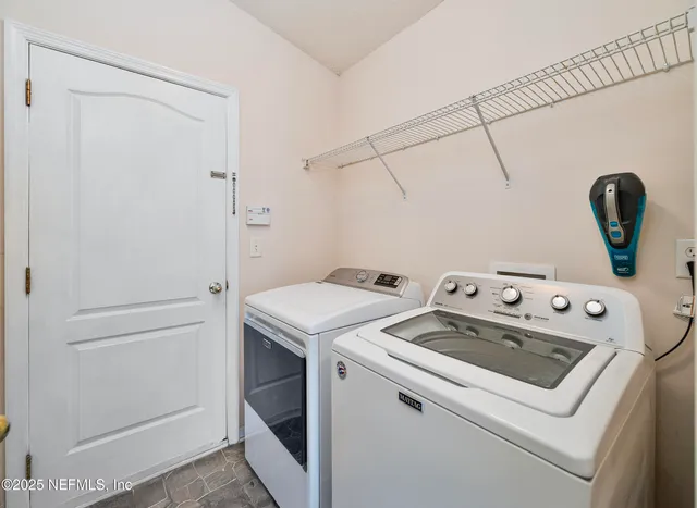 a spacious bedroom with a bed and a chandelier