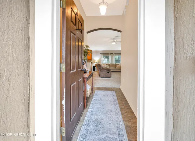a view of a room with a table and a potted plant