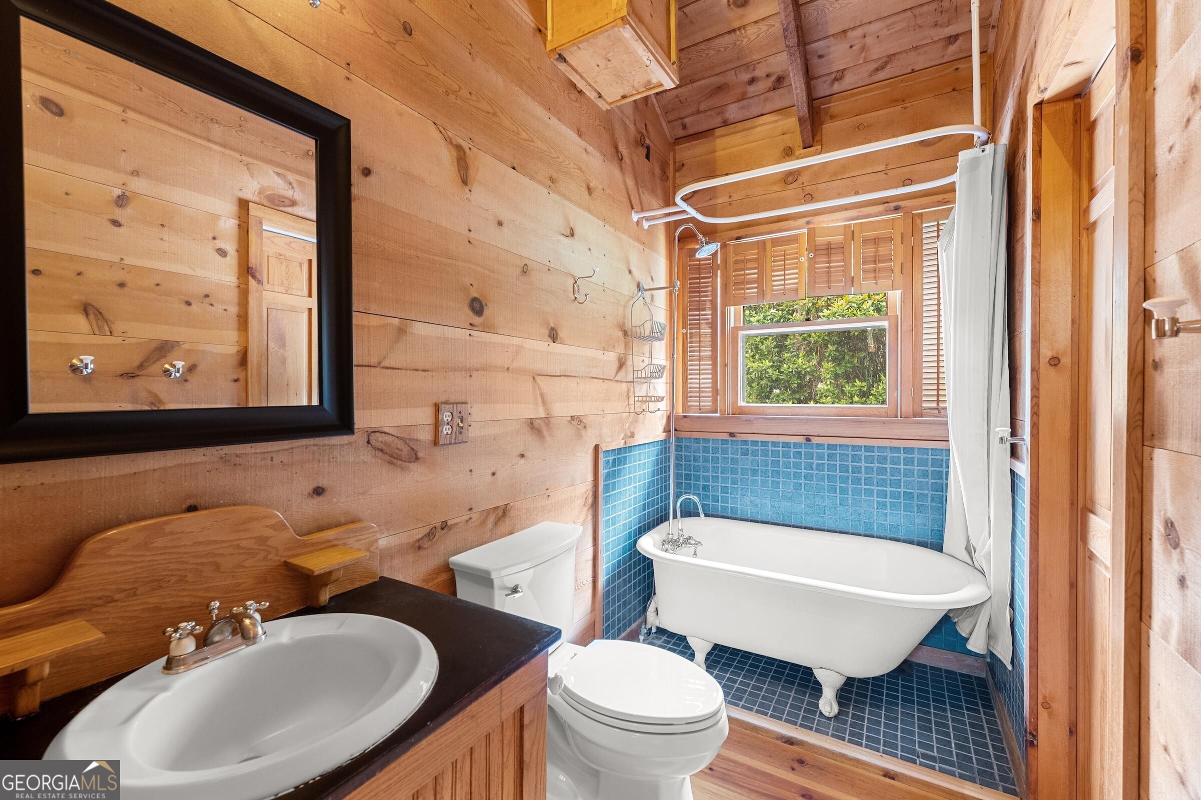 966 Wahoo Creek Road Murrayville, GA 30564 - Photo 23 of 81 a bathroom with a sink a mirror a toilet and a window