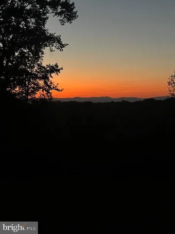 a dining room with furniture window and wooden floor