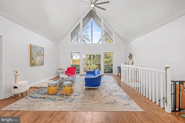 a living room with furniture a rug and a window