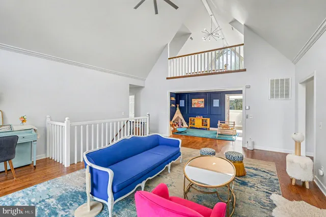 a kitchen with a sink dishwasher a stove and white cabinets with wooden floor
