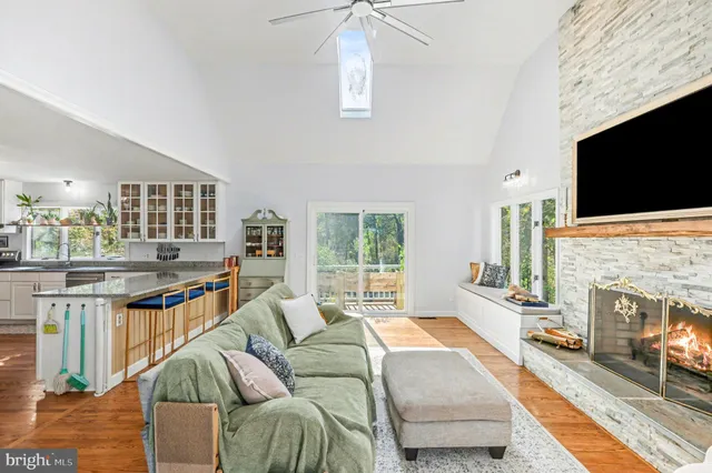 a living room with patio furniture and wooden floor