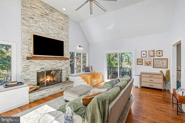 a living room with furniture fireplace and a large window